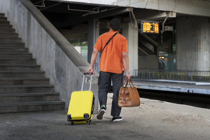 full-shot-man-traveling-with-baggage